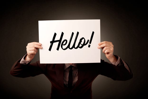 Young businessman hiding behind a greeting drawn on paper